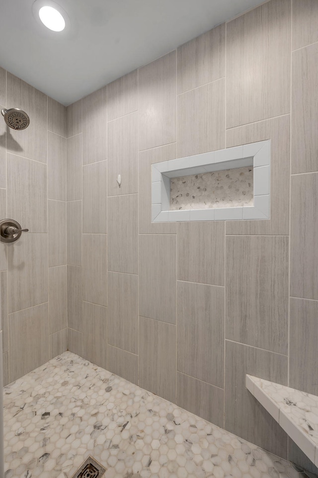 bathroom with tiled shower