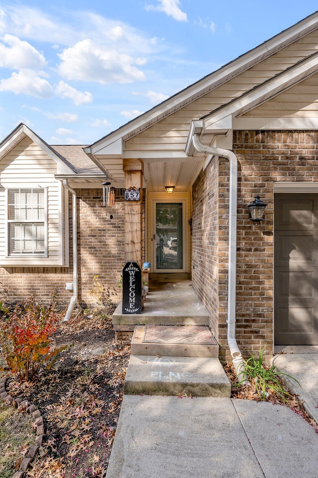 view of exterior entry with a garage