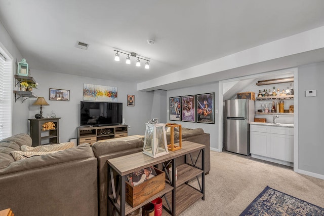 carpeted living room with indoor bar