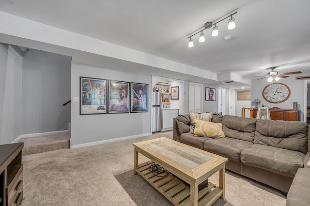 living room with ceiling fan, rail lighting, and light carpet