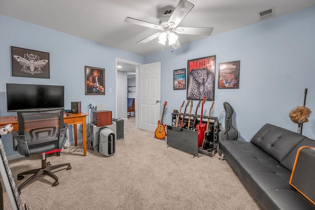 carpeted home office featuring ceiling fan