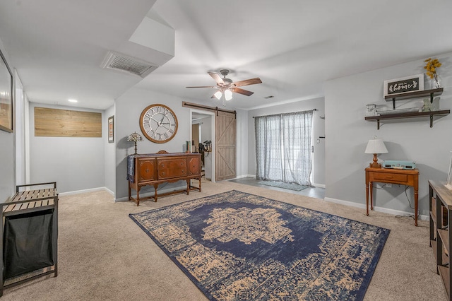 foyer featuring a barn door, light carpet, and ceiling fan