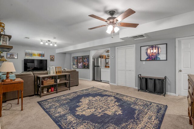 living room featuring light carpet and ceiling fan