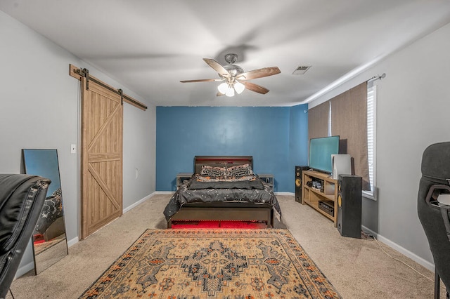 carpeted bedroom featuring multiple windows, a barn door, and ceiling fan