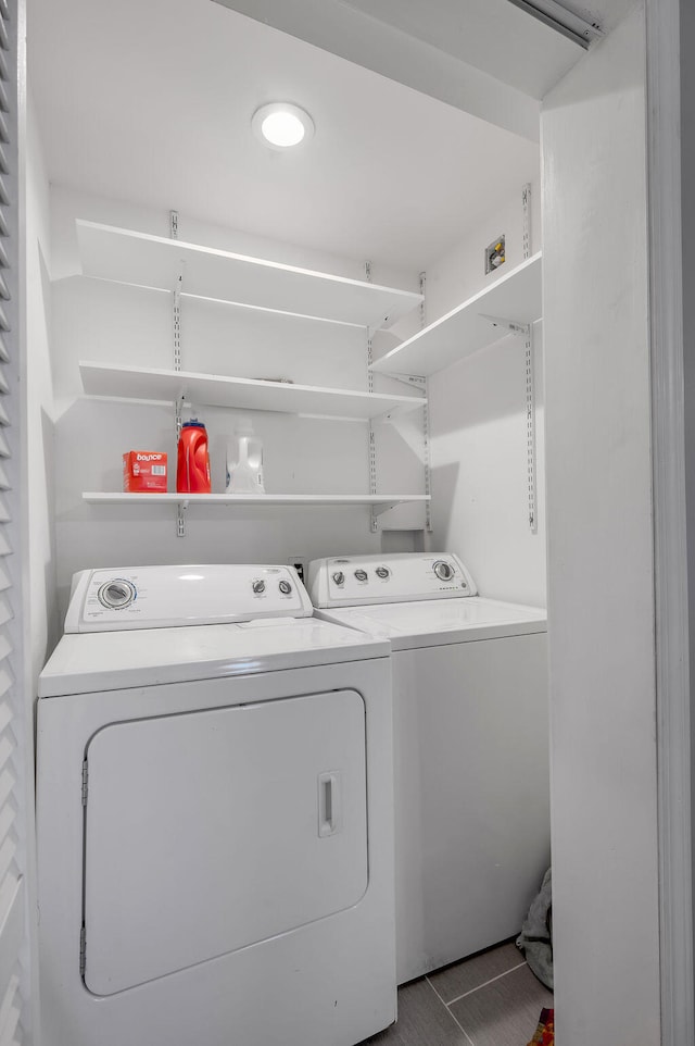 laundry area with washing machine and dryer and tile patterned floors