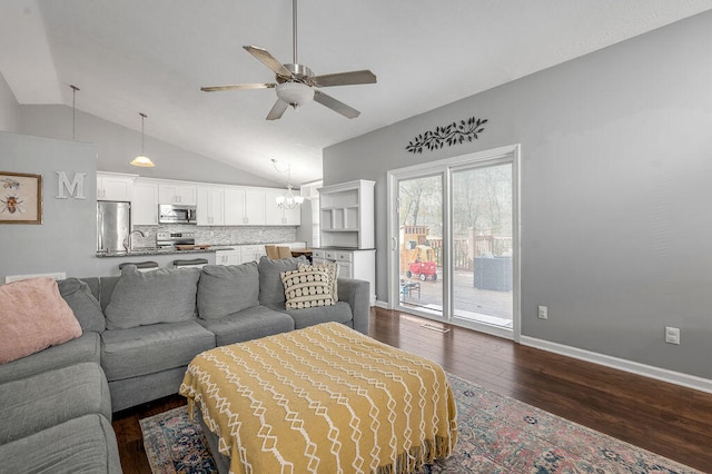 living room featuring vaulted ceiling, ceiling fan with notable chandelier, sink, and dark hardwood / wood-style flooring