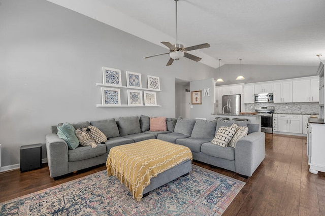 living room featuring ceiling fan, dark hardwood / wood-style floors, and vaulted ceiling