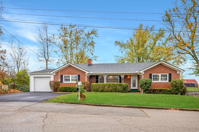 single story home featuring a front lawn and a garage