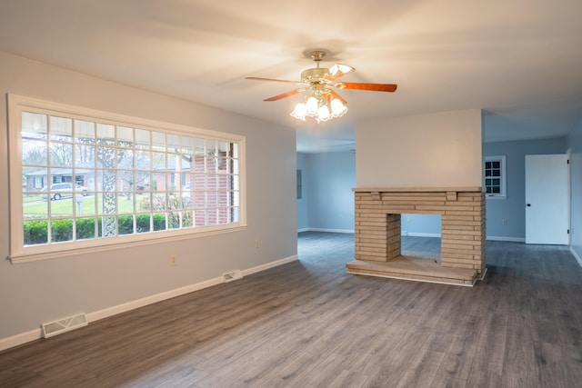 unfurnished living room with ceiling fan, dark hardwood / wood-style floors, and a fireplace