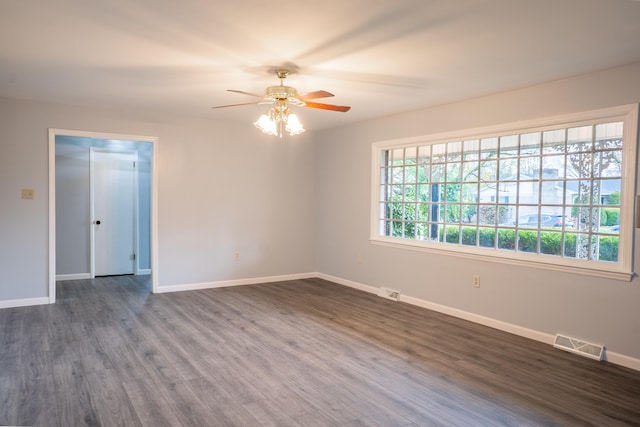 spare room with ceiling fan and dark hardwood / wood-style flooring