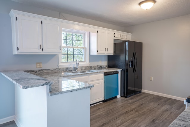 kitchen with white cabinets, kitchen peninsula, and stainless steel dishwasher