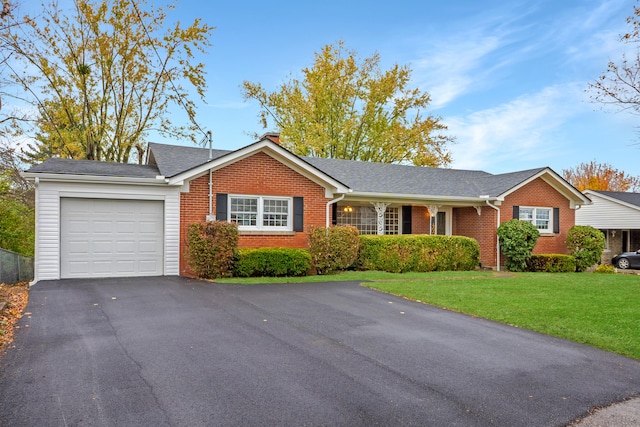 ranch-style house featuring a garage and a front lawn