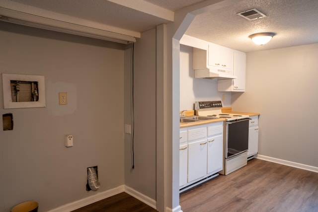 kitchen with electric stove, a textured ceiling, light hardwood / wood-style floors, and white cabinets