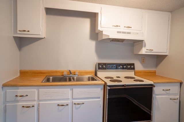 kitchen featuring white cabinets, a textured ceiling, and white electric stove