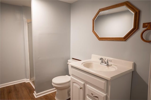 bathroom featuring vanity, hardwood / wood-style flooring, and toilet