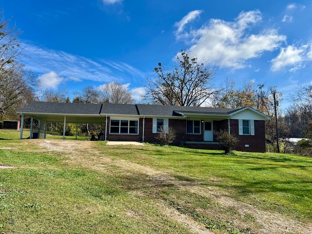 ranch-style house featuring a front yard and a carport