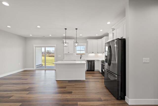 kitchen with premium range hood, appliances with stainless steel finishes, a center island, and white cabinetry