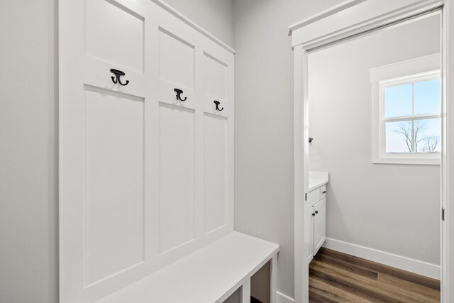 unfurnished bedroom featuring a barn door, crown molding, baseboards, and recessed lighting