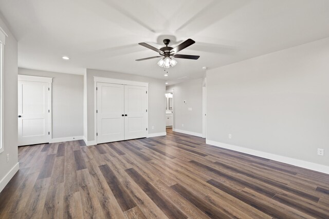 unfurnished bedroom with baseboards, recessed lighting, a closet, and dark wood finished floors