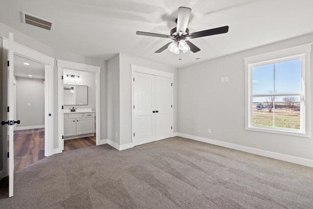 view of side of property featuring a yard, cooling unit, driveway, brick siding, and a garage