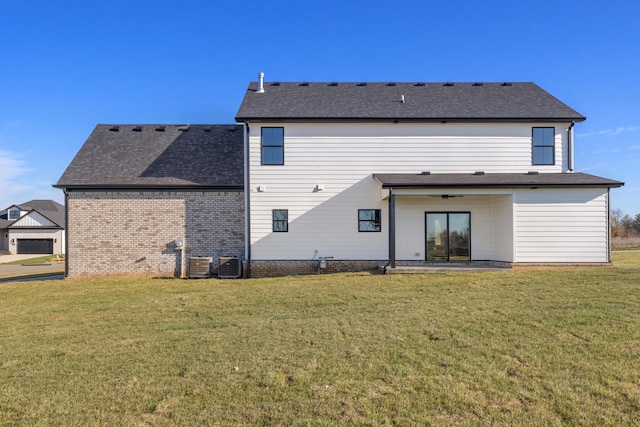 back of house featuring a lawn, a patio area, and central AC unit