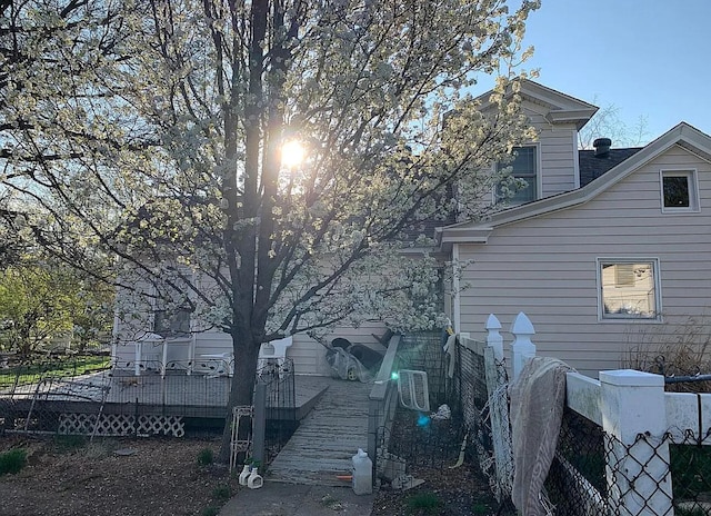 rear view of property featuring a deck