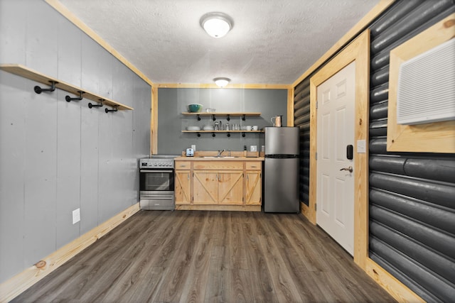 kitchen featuring appliances with stainless steel finishes, light brown cabinets, dark hardwood / wood-style floors, a textured ceiling, and sink