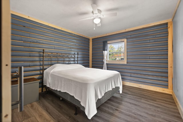 bedroom with dark wood-type flooring and ceiling fan