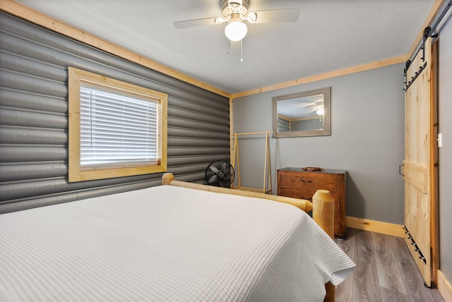 bedroom featuring ceiling fan, wood-type flooring, and crown molding