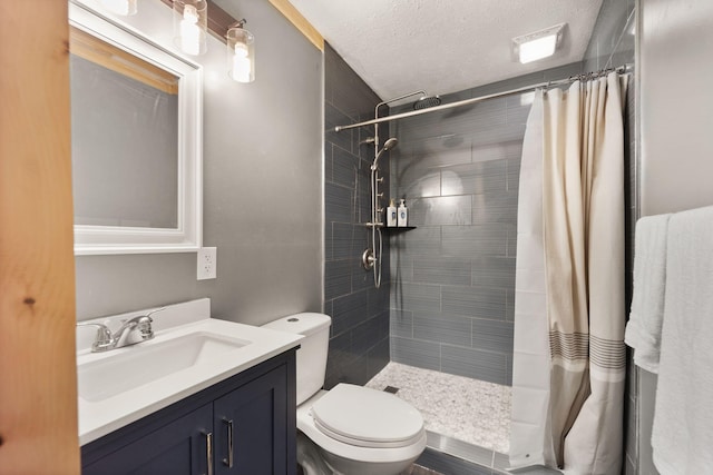 bathroom featuring a textured ceiling, toilet, vanity, and a shower with shower curtain