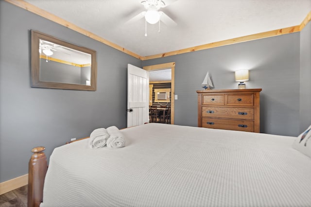 bedroom with ceiling fan and hardwood / wood-style floors