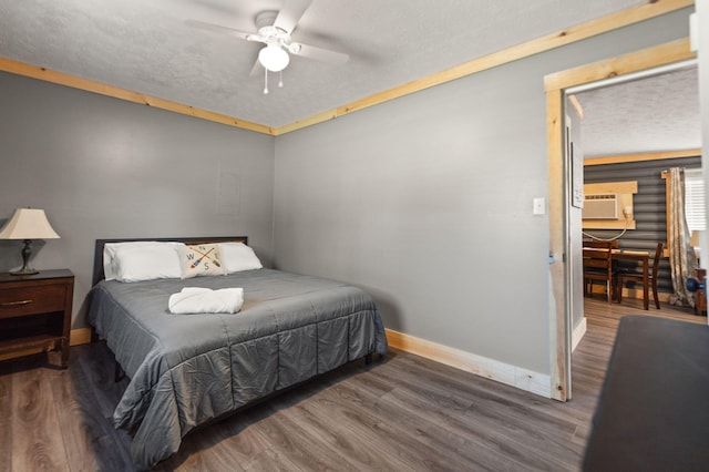 bedroom featuring ceiling fan, cooling unit, and dark hardwood / wood-style floors