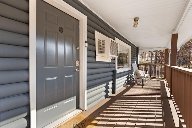 property entrance with a wall mounted AC and covered porch