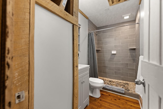 bathroom with toilet, a shower with curtain, wood-type flooring, and vanity