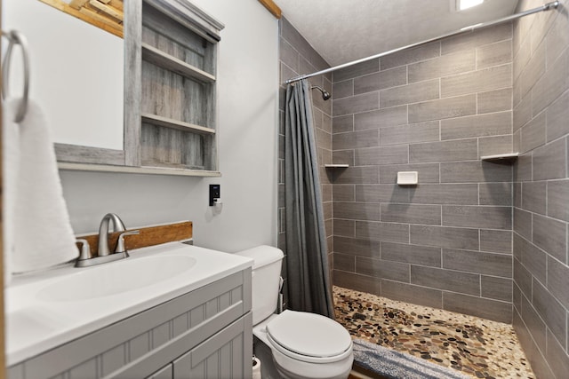 bathroom with toilet, vanity, and curtained shower