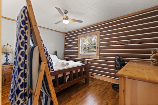 bedroom with dark hardwood / wood-style floors and a textured ceiling