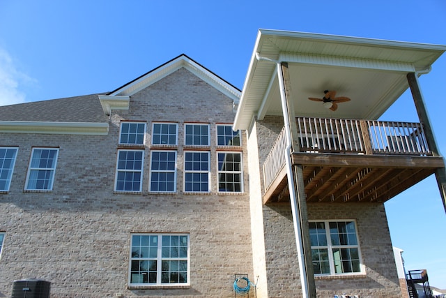 back of house with central air condition unit and ceiling fan