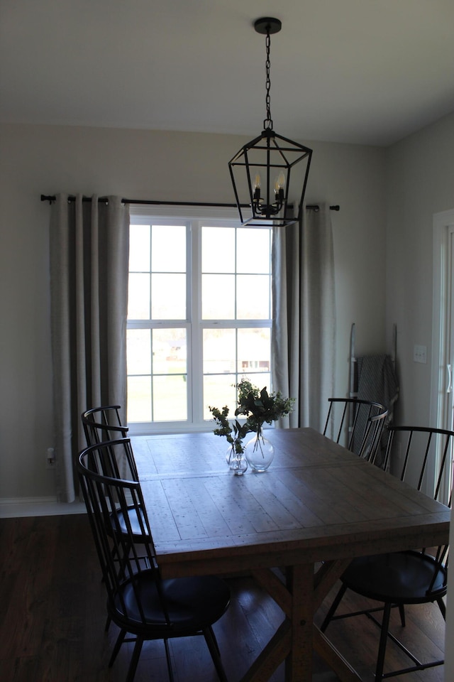 dining area featuring a notable chandelier and dark hardwood / wood-style floors