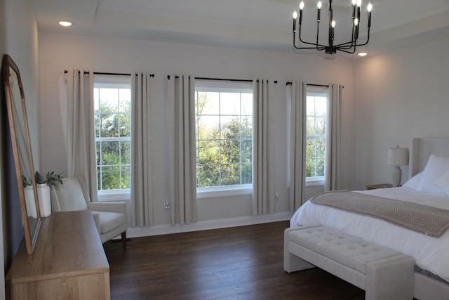 bedroom featuring a chandelier and dark hardwood / wood-style flooring