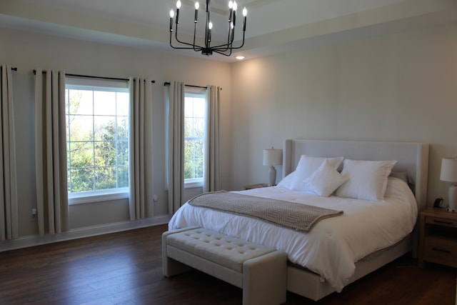 bedroom featuring a notable chandelier and dark hardwood / wood-style floors