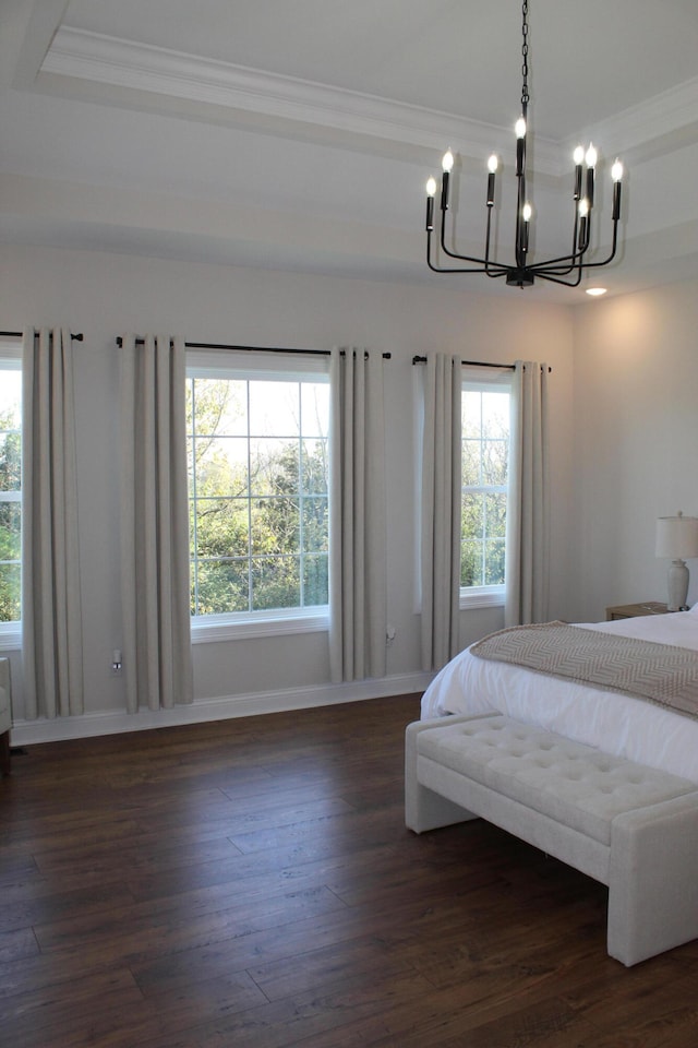 bedroom featuring dark wood-type flooring, an inviting chandelier, and crown molding