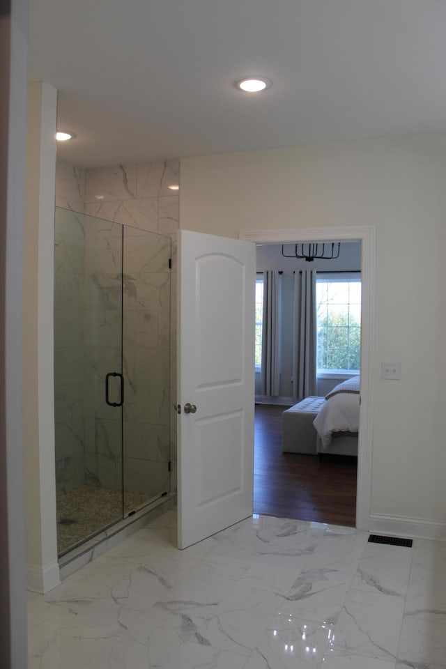 bathroom with wood-type flooring and a shower with shower door