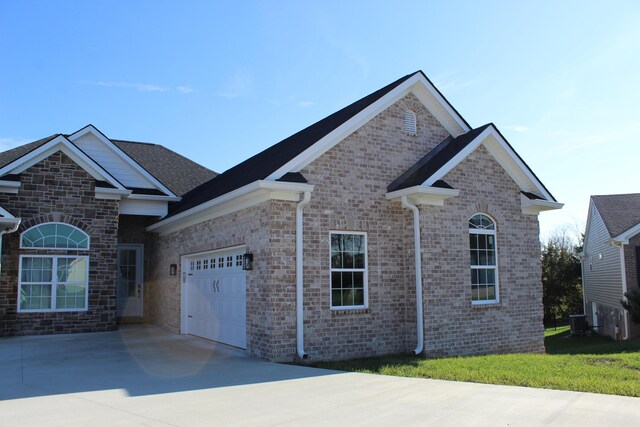 212 Patrum Sisters Way, Danville, KY 40422 - view of front of home featuring driveway, a garage, central air condition unit, and brick siding