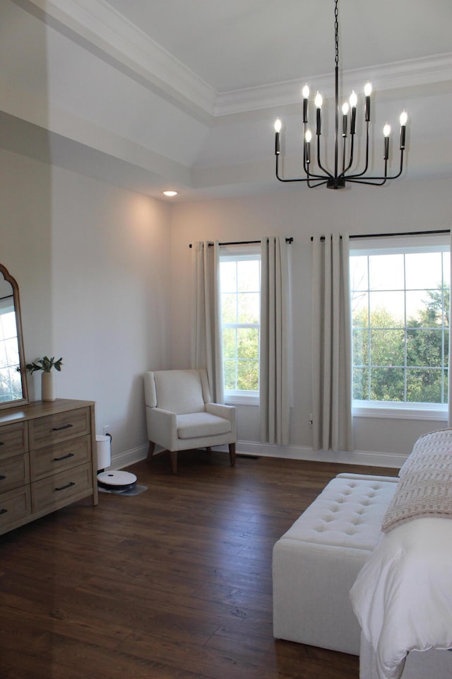 sitting room with dark hardwood / wood-style floors, an inviting chandelier, and crown molding