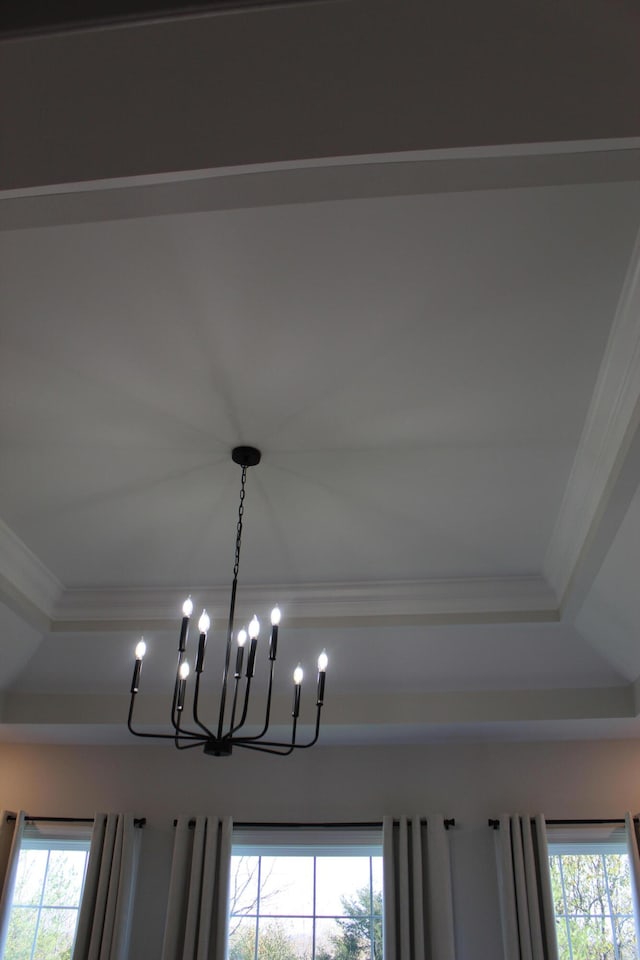 interior details with an inviting chandelier and crown molding