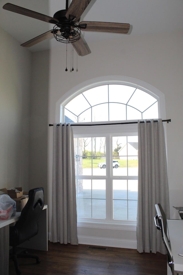 home office featuring ceiling fan, dark hardwood / wood-style floors, and a water view