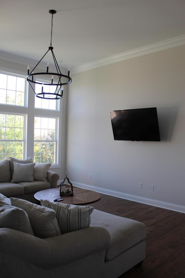 living room with dark hardwood / wood-style floors, a chandelier, and ornamental molding