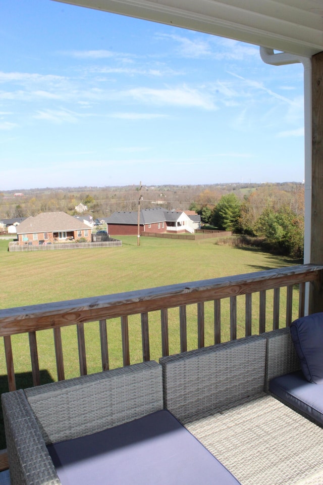 wooden deck featuring a lawn