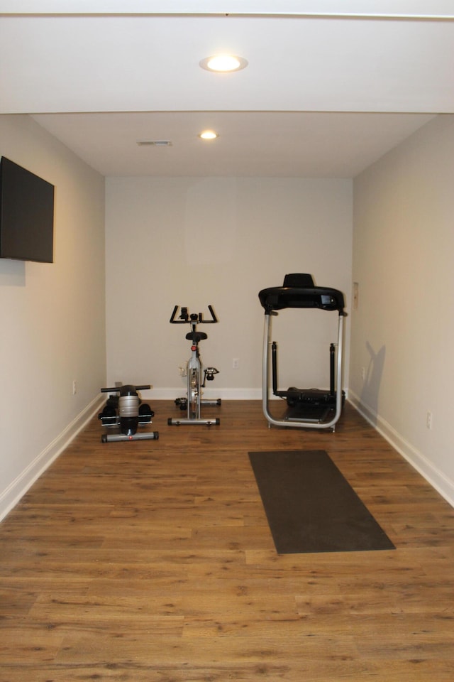 workout area with hardwood / wood-style flooring