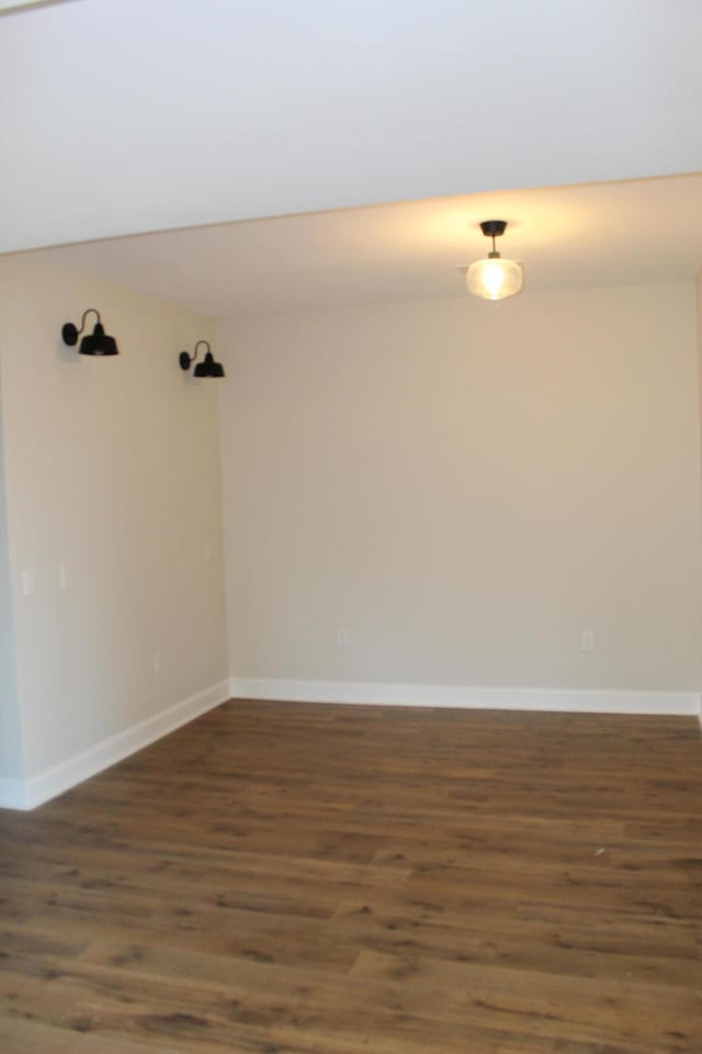 empty room featuring dark hardwood / wood-style flooring